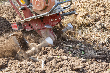 Motoblock plows soil