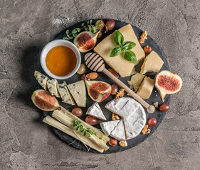 Cheese plate served with wine, nuts and honey 