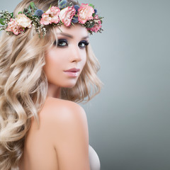 Beautiful Young Woman with Flowers Hairstyle. Fashion Model with Long Permed Curly Hair and Perfect Makeup