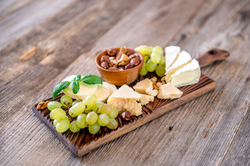 Cheese plate served with nuts and honey