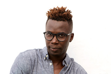 Fototapeta premium Close up serious african man with glasses against white background