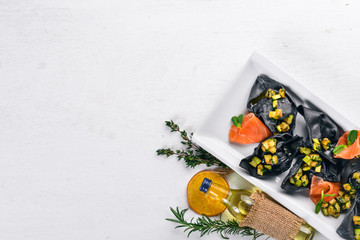 Ravioli with meat. Italian food. On a wooden surface. Top view. Free space for your text.