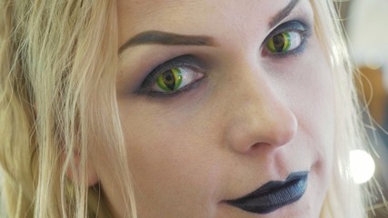 Close-up portrait of young pretty woman with halloween makeup at beauty salon