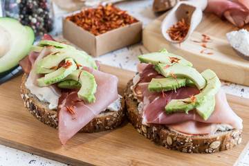 fresh bread with cottage cheese, prosciutto , avocado and saffron