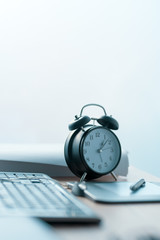 Business project deadline, vintage clock on office desk