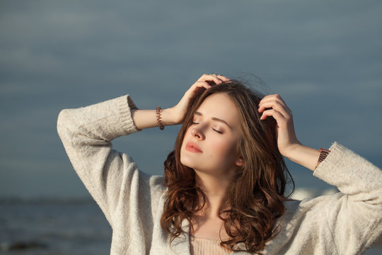 Nice Woman in Sunlight Outdoors. Perfect Woman on Blue Sea Background
