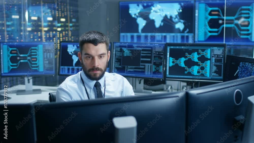 Fototapete monitoring room operator observes system stability, rapidly moving from one display to another. scre