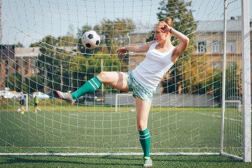 Female athlete does sport exercises in the stadium