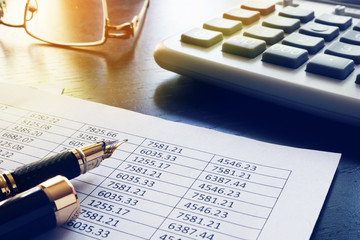 Office table with business report and financial documents.