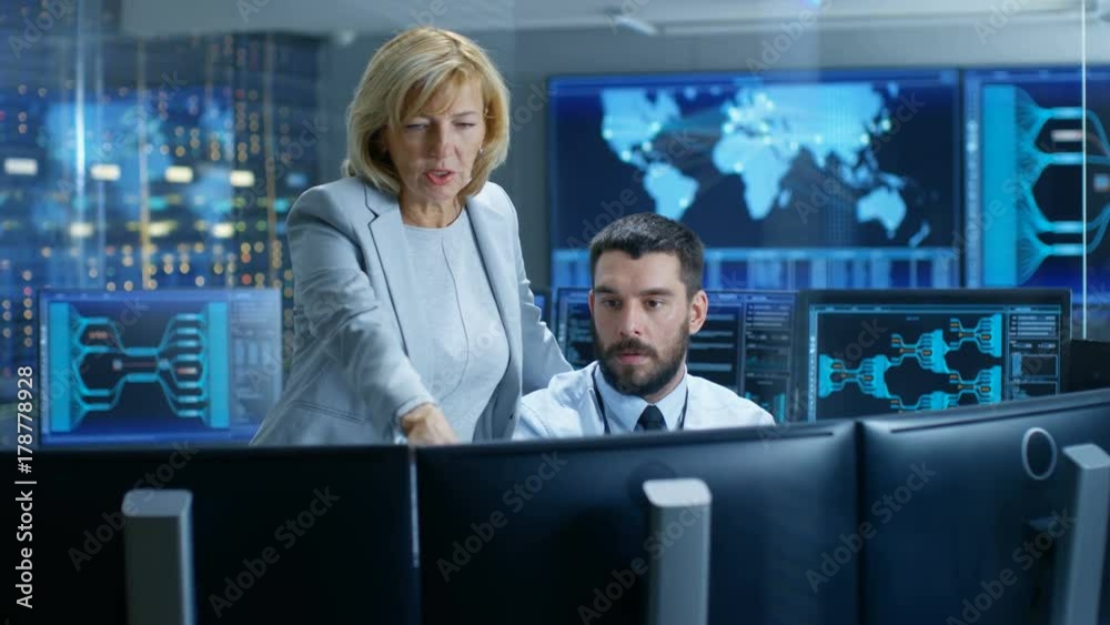 Poster in the system monitoring room senior supervisor controls work of the operator. they're surrounded by