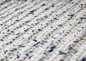 Gray knitted background. Knitted texture. A sample of knitting. Knitting Pattern.