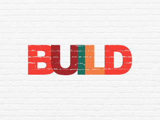 Constructing concept: Painted multicolor text Build on White Brick wall background