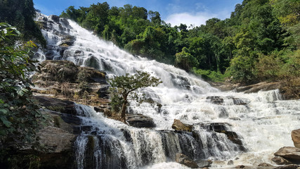 Beautiful panoramic  view of Mae YA waterfall with low angle shot in the forest in Chomthong district, Chiamgmai province ,Thailand.