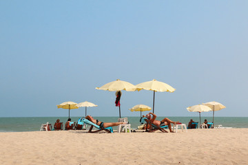sunbathing on the beach in Thailand.