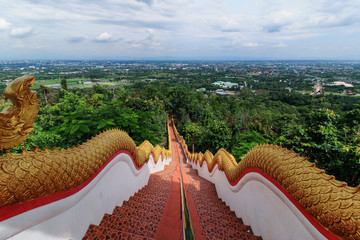 The Naga stairway down from Wat Phra That DoiKham buddhist temple in Chiang Mai, Thailand with panoramic view of Chiangmai cityscape. - obrazy, fototapety, plakaty