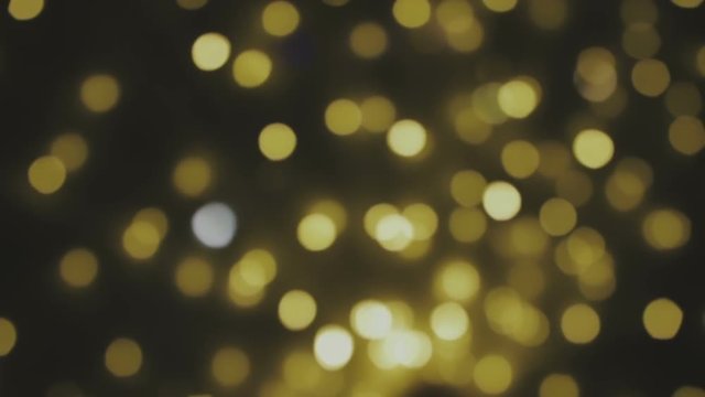 Golden, blurred, bokeh lights background. Abstract sparkles. Full HD loop, 1080p