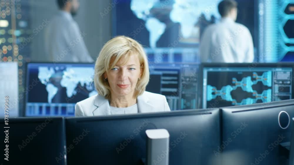 Aufkleber system monitoring room professional female operator observes correct functioning of the facility. in