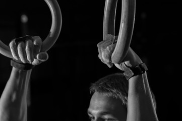 Cropped shot of male hands on gymnastics rings