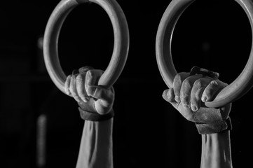 Cropped shot of male hands on gymnastics rings