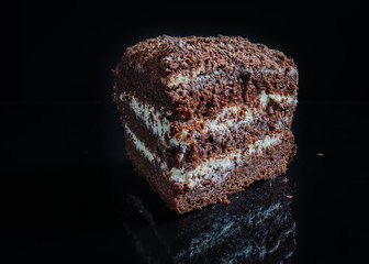 Delicious chocolate cake on a black background