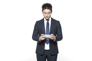 business man standing up with smart phone isolated white.