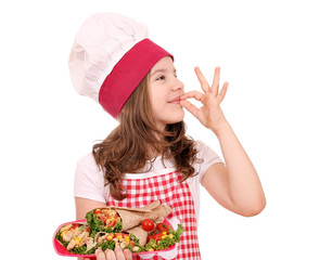 little girl cook with burritos and ok hand sign