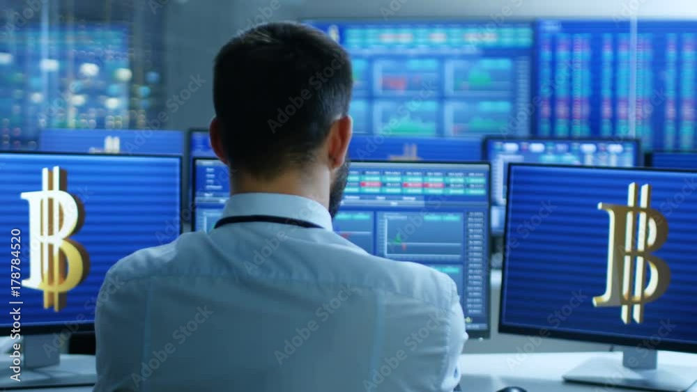 Poster stock exchange trader works with cryptocurrency at his workstation. screens show ticker numbers and 