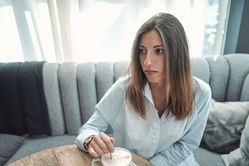 A spoonful of sugar is put in coffee