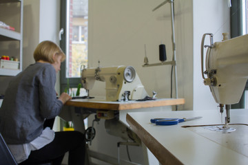 female tailors working at the sewing machine in studio   