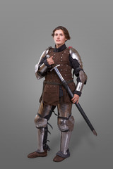 Obraz premium portrait of a medieval female knight in armour over grey background