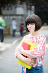 Portrait Of Female Teenage Student Outside School Building