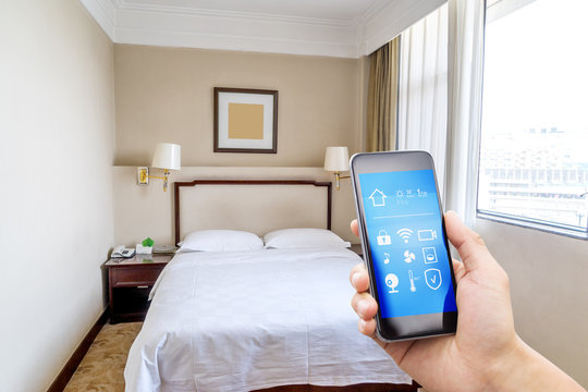 smart phone with smart home app in modern bedroom