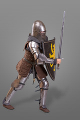 knight in breaths in a helmet with a sword and shield in battle over grey background