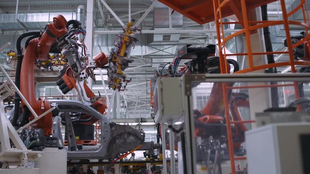 Automobile plant, robot equipment, welding process and assembly line of cars, modern production.
