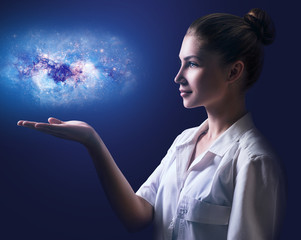 Female doctor showing little galaxy on her hand.