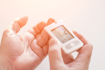Medicine, diabetes, glycemia, health care and people concept - Close up of man hands testing high...