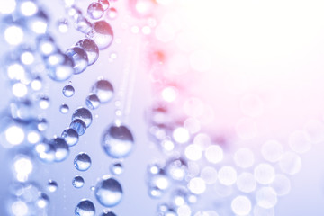 Round drops of dew on a cobweb in the sunlight, abstract background