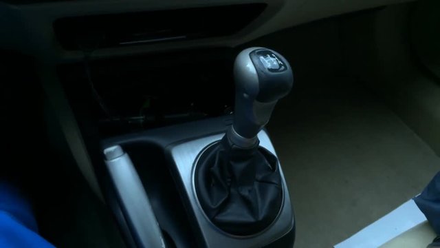 Time lapse of using stick shift in car while driving