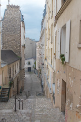 Fototapeta na wymiar Typical alley in Montmartre, romantic staircases in Paris 