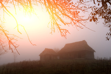 Alone house on foggy meadow
