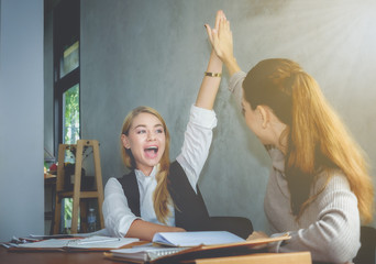 Two business women are happy to succeed in business. Business Concepts Teamwork.