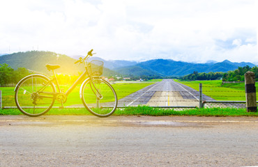 Obraz premium A bicycle stands at near of a runway and mountain with blue sky
