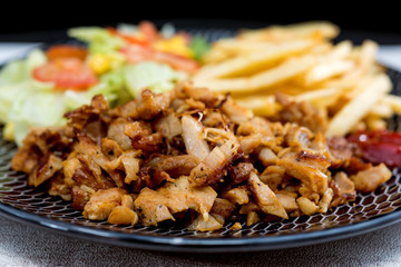 Fresh chicken steak with tomatoes and french fries