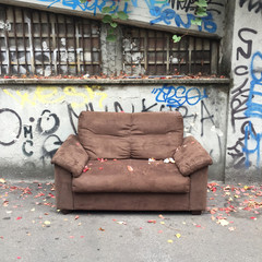 Milan, Italy - October 20, 2017 : Abandoned sofa