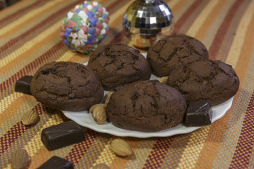  Chocolate Cookies on White Saucer. White Saucer on Color Napkin.