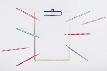 clipboard with colorful pencil on the white background.
