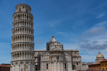 Stunning daily view at the Pisa Baptistery, the Pisa Cathedral and the Tower of Pisa. They are located in the Piazza dei Miracoli (Square of Miracles) in Pisa, Italy. 