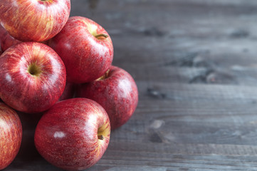 red, juicy apples on the table, space for text