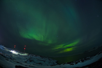 Fototapeta na wymiar Aurora Borealis (Northern Lights) above coastal sea