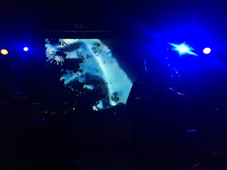 Obraz na płótnie Canvas Blue lights, silhouette of musicians at the stage 
